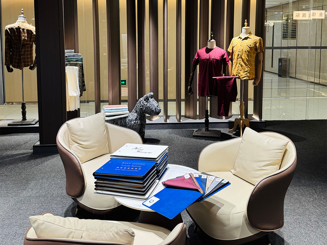 Showroom interior featuring diverse textile collections including spandex fabric and premium suiting material